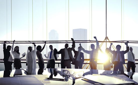 Group Of Business People Celebrating In Board Room